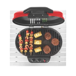 Coleman RoadTrip® 225 Portable Tabletop Propane Grill -Outdoor camping equipment-Coleman 2000033047 coleman grills 225 TT heritage red flames turned on food on grates overhead 3